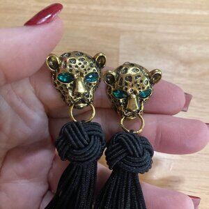 Long Black Tassel Earrings Hanging From Golden Leopard Face With Green Eyes
